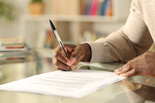 Person signing a document.