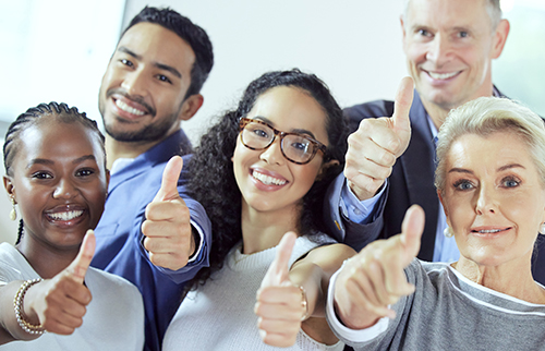 Group of people giving thumb's up.