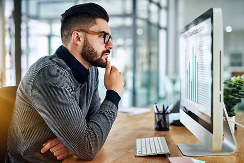 Man studying computer screen.