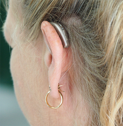 Photo by Mark Paton of a hearing aid on a woman's ear