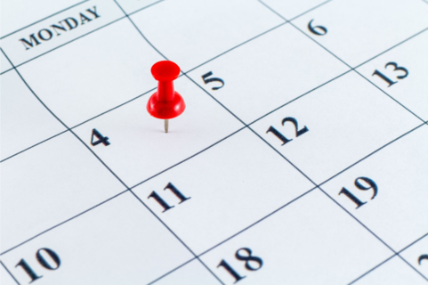 Thumbtack on a calendar date