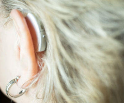 Close up of a woman wearing a hearing aid