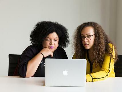 Two women looking at a laptop together