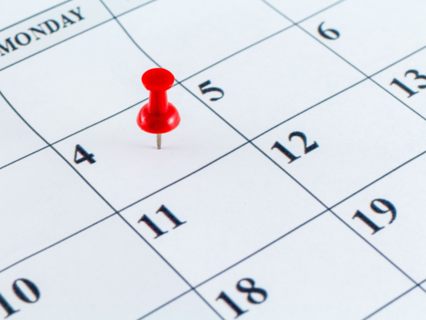 Thumbtack on a calendar date