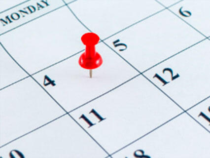 Thumbtack on a calendar date