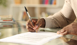 Person signing a document.